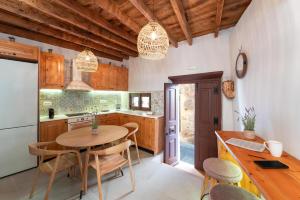 a kitchen with a table and chairs in a kitchen at Rodos Old Town Aqua Luxury House in Rhodes Town