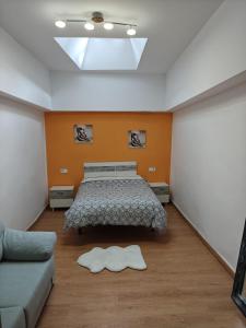 a bedroom with a bed and a couch at Casa Diego in Melias