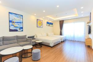 a living room with a couch and tables at FLC SEA TOWER YẾN MINH Apartment in Quy Nhon +50 photos