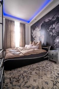 a bedroom with a large bed with a blue ceiling at Apartmenthaus in der Delitzscher Str in Halle-Saale nähe Hauptbahnhof in Halle an der Saale +72 photos