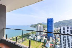a balcony with a view of the ocean and buildings at FLC SEA TOWER YẾN MINH Apartment in Quy Nhon