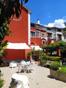 Un patio con mesas y sillas frente a un edificio. en Villa Elvira, en Pellezzano 36 fotos más