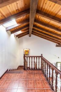 a staircase in a house with wooden ceilings at Your retreat on the Asturian coast in Andrín