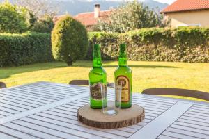 two bottles of beer sitting on top of a table at Your retreat on the Asturian coast in Andrín +33 photos