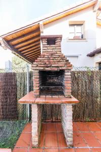a brick oven sitting on top of a patio at Your retreat on the Asturian coast in Andrín