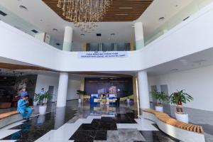 a lobby with a table and chairs and a chandelier at FLC SEA TOWER YẾN MINH Apartment in Quy Nhon