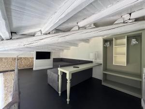 a room with a desk and a couch and a tv at Palazzo Franceschini in Cascia +41 photos