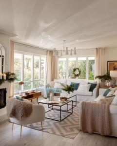 a living room with white furniture and large windows at Wishome-Villa sobre el mar en Comillas, con piscina in Comillas