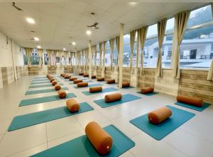 a row of yoga mats in a room with windows at Zuna Stayz Tapovan Rishikesh in Rishīkesh