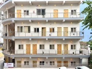 a large white building with a large balcony at Zuna Stayz Tapovan Rishikesh in Rishīkesh
