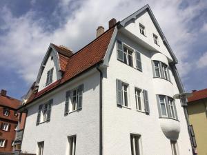 a white building with a red roof at Villa Friedrich in Bayreuth