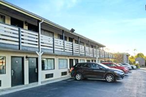 a car parked in a parking lot next to a building at Brookville Inn By OYO Near Dayton International Airport in Brookville