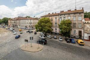 a city street with cars parked in front of buildings at Studio on Kopernyka street in Lviv