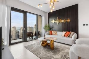 a living room with a couch and a table at Novity Luxury Vida Marina 2BR Sea View 40th Floor in Dubai +29 photos