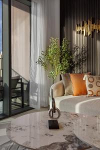 a living room with a couch and a glass table at Novity Luxury Vida Marina 2BR Sea View 40th Floor in Dubai