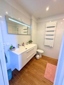 a white bathroom with a sink and a toilet at Superbe maison en pierre in Sault-Brénaz +52 photos