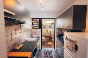 a kitchen with a sink and a counter top at Kaz Nomia - à 50m de la plage Roches Noires in Saint-Gilles les Bains