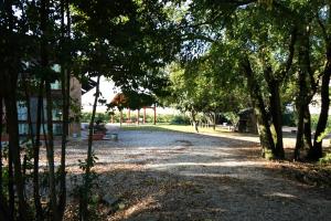 a gravel road with trees in a park at Agriturismo Venice Photobirding in Tessera +10 photos