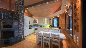a kitchen with a table and chairs and a stove at Lakeside Hideaway in Rovaniemi