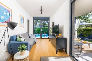 BadernaにあるVilla Barcolana by Villsyの青いソファとテレビのあるリビングルーム