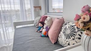 a bed with stuffed animals on it in a bedroom at EtyekZen in Etyek +20 photos