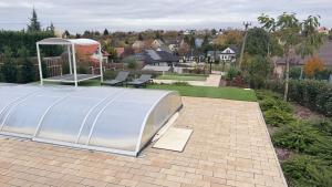 a metal structure on top of a brick patio at EtyekZen in Etyek