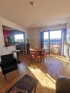 a living room with a dining room table and chairs at Le charme de Montmartre à ciel ouvert in Paris +21 photos