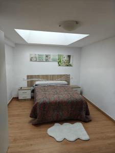 a bedroom with a bed with a rug on the floor at Casa Diego in Melias