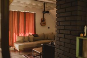 a living room with a couch and a guitar at Forrest House in Doboj +33 photos