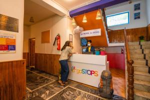 a woman standing at a counter at a restaurant at goSTOPS Kasol in Kasol +85 photos