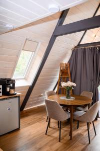 a dining room with a table and chairs in a attic at Дім у Карпатах in Rechka