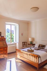 a bedroom with a large bed and a window at Villa dei Muralti- 2 free parkings in Muralto +81 photos