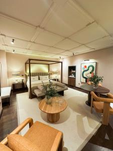 a large living room with a bed and a large mirror at Hospes Palacio del Bailio, a Member of Design Hotels in Córdoba