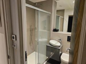 a bathroom with a glass shower and a toilet at Luxury 2 double bedroom Apt in the heart of Purley in Purley