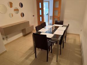 a dining room with a table and chairs at Y&To in Grao de Castellón +65 photos