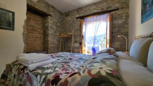 a bedroom with a bed in front of a window at A Casuzza in Caronia