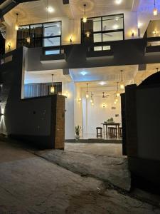 a room with a staircase in a building with a table at Tropictide Weligama in Nikawatawana