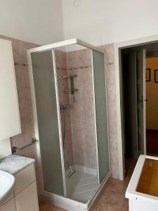 a shower with a glass door in a bathroom at A casa della nonna in Imola