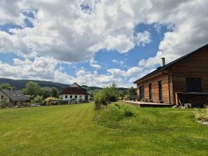 a large grass field next to a building at Apartmány Stachy Popelná in Stachy