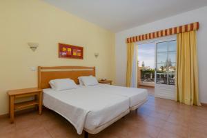 ルースにあるLuz Bay Hotelのベッドとガラスの引き戸のある寝室 +144枚の写真