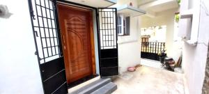 an entrance to a house with a wooden door at Miracle Stay in Madurai