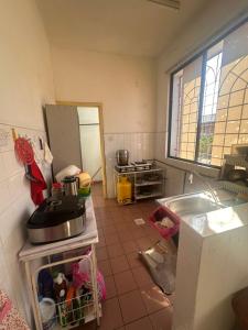 a kitchen with a sink and a counter top at Sweet home Beverly hills in Penampang