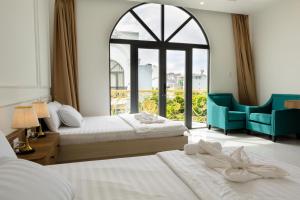 Ένα ή περισσότερα κρεβάτια σε δωμάτιο στο Fara Home - Phan Rang Homestay