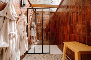 a shower with a glass door in a bathroom at Lov'nid 'spa & sauna' in Domme