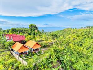 an aerial view of a house on a hill at Ayu Hill Bungalows in Nusa Penida +26 photos