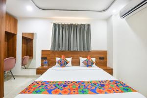 a bedroom with a large bed and a window at FabHotel Sky I in Gurgaon +15 photos