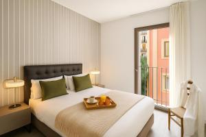 Ένα ή περισσότερα κρεβάτια σε δωμάτιο στο Aspasios Catedral Apartments +15 φωτογραφίες