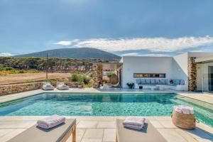 a villa with a swimming pool with a view at Villa Raphael - Luxury and Serenity in Paros in Naousa