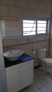 a bathroom with a sink and a toilet at Christmas Rock, East London in Christmas Vale