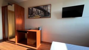 a room with a desk and a tv on a wall at B&B HOTEL Tarragona Reus in Reus